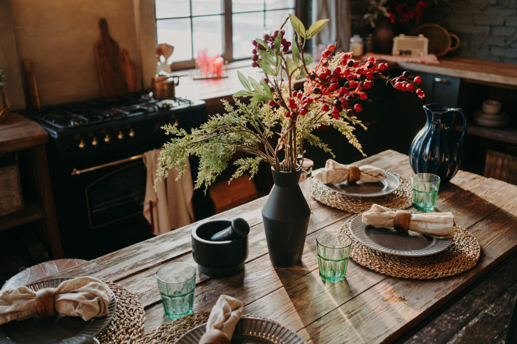 Served nicely decorated dining table with plates napkins vase. Kitchen background interior. Catering concept. Retro style. Interior design